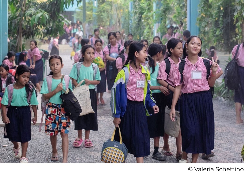 Happy Chandara students walking to class on the educational campus in Cambodia